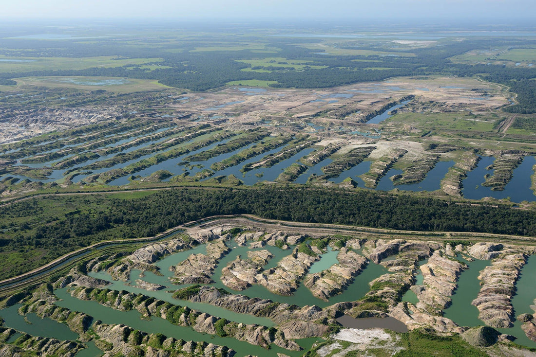 Aerial view of phosphogypsum stacks in Florida showing large phosphate mining waste piles and water channels near Tampa Bay