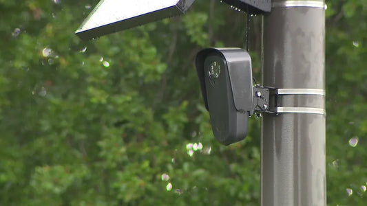 Automated license plate reader camera mounted along a Florida roadway as FDOT orders the devices removed from state highway rights of way