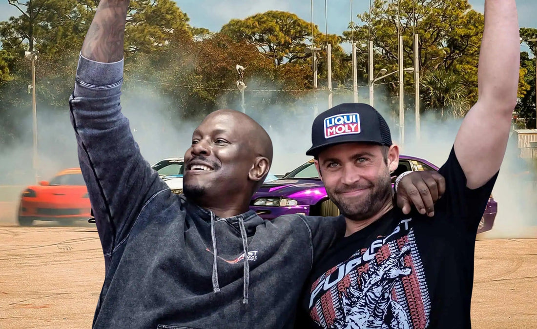 Tyrese Gibson and Cody Walker celebrating on stage at FuelFest 2026 in Tampa, with drift cars performing behind them at the Florida State Fairgrounds.