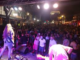 First Friday St. Pete live music performance on Central Avenue with large crowd gathered at night in downtown St. Petersburg Florida