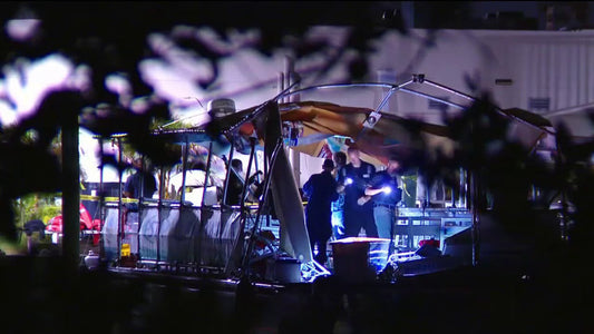 Emergency responders inspect the heavily damaged Clearwater Ferry at night after a private boat struck the passenger vessel near the Memorial Causeway.