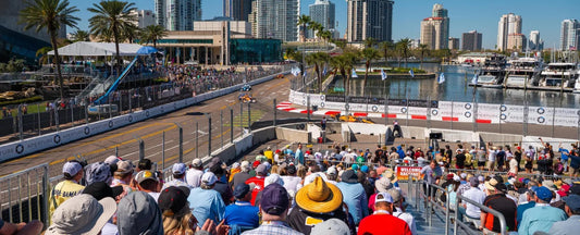 Spectators watch IndyCar racing from waterfront grandstands along the downtown St. Petersburg street circuit during the Firestone Grand Prix of St. Petersburg