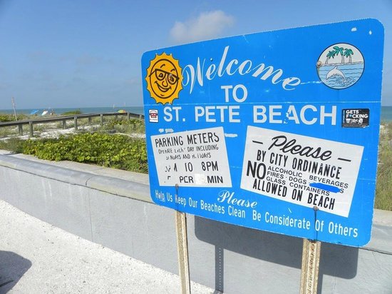 St. Pete Beach welcome sign with beach rules and ordinance notices near the shoreline in Pinellas County Florida