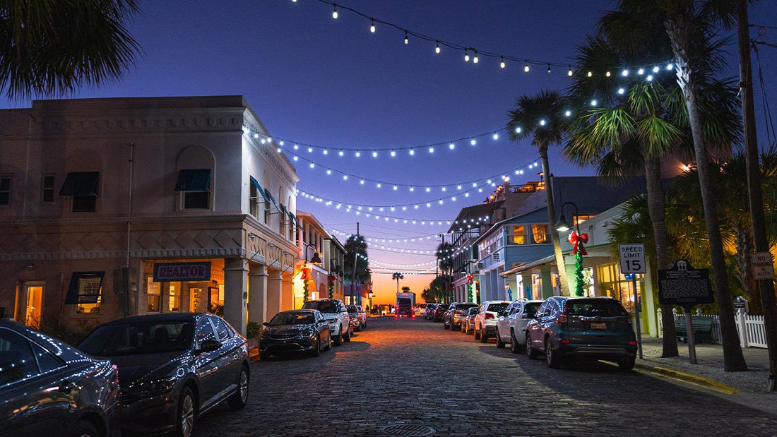 Pass a Grille beach street at sunset with string lights, parked cars, and coastal neighborhood atmosphere on St Pete Beach Florida