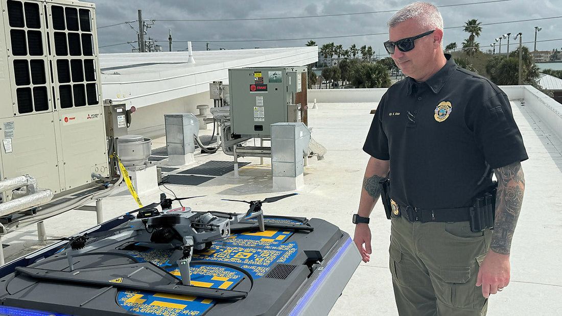 Clearwater Police officer standing beside public safety drone used during Spring Break pilot program to monitor crowds on Clearwater Beach
