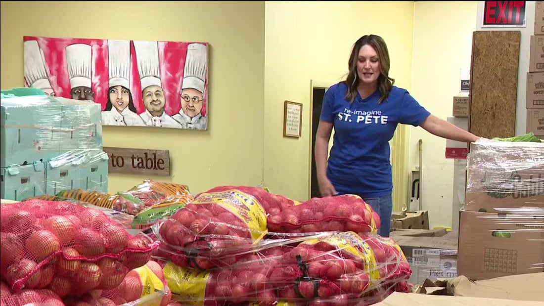 Volunteers at Positive Impact St. Pete organize fresh produce and recovered hospitality food from the Firestone Grand Prix of St. Petersburg, preparing meals for distribution to families across St. Pete.
