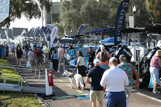 Visitors walking the docks and exhibitor tents at the St. Petersburg Power & Sailboat Show on the St. Pete waterfront